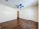 Bedroom featuring wood floors, ceiling fan, and closet at 12822 Moss Park Ridge Dr, Orlando, FL 32832
