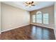 Cozy bedroom with hardwood floors, ceiling fan, and abundant natural light from the windows at 12822 Moss Park Ridge Dr, Orlando, FL 32832