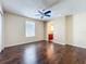 Bedroom with wood flooring, ceiling fan, and an ensuite bathroom at 12822 Moss Park Ridge Dr, Orlando, FL 32832