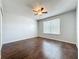 Bedroom featuring hardwood floors, a ceiling fan, and a bright window at 12822 Moss Park Ridge Dr, Orlando, FL 32832