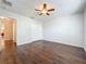 Spacious bedroom featuring hardwood floors, ceiling fan, and a double door closet at 12822 Moss Park Ridge Dr, Orlando, FL 32832