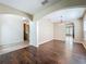 Open-concept dining room with hardwood floors, arched doorways, and elegant lighting fixture at 12822 Moss Park Ridge Dr, Orlando, FL 32832