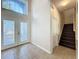 Welcoming entryway with tile floors, decorative front doors, and a staircase at 12822 Moss Park Ridge Dr, Orlando, FL 32832