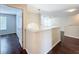 Upper hallway featuring hardwood floors, white railing, with views to other rooms at 12822 Moss Park Ridge Dr, Orlando, FL 32832