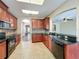 Open kitchen with tile flooring, granite countertops, and stainless steel appliances at 12822 Moss Park Ridge Dr, Orlando, FL 32832