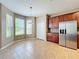 Eat-in kitchen area with natural light, stainless steel refrigerator, and tile floors at 12822 Moss Park Ridge Dr, Orlando, FL 32832