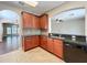 Kitchen features black appliances, black granite countertops, cherry cabinets and tile backsplash at 12822 Moss Park Ridge Dr, Orlando, FL 32832