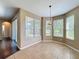 Bright breakfast nook with multiple windows overlooking the backyard and sliding glass door at 12822 Moss Park Ridge Dr, Orlando, FL 32832