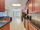 Open concept kitchen with black appliances, black granite countertop, and tile floors at 12822 Moss Park Ridge Dr, Orlando, FL 32832