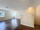 Spacious living room featuring wood floors, natural light from three windows, and a ceiling fan at 12822 Moss Park Ridge Dr, Orlando, FL 32832