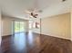 Open living room showcases hardwood flooring and sliding glass doors to the backyard at 12822 Moss Park Ridge Dr, Orlando, FL 32832
