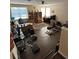 View of the living room with a ceiling fan, hardwood floors, and bookshelves at 12822 Moss Park Ridge Dr, Orlando, FL 32832