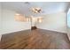 Well-lit living room features hardwood floors, ceiling fan, and an open layout at 12822 Moss Park Ridge Dr, Orlando, FL 32832