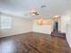 Open-concept living room with hardwood floors, multiple windows, and seamless transition to upper level at 12822 Moss Park Ridge Dr, Orlando, FL 32832