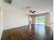 Bright living room featuring hardwood floors, ceiling fan, and sliding glass doors at 12822 Moss Park Ridge Dr, Orlando, FL 32832