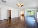 Spacious main bedroom featuring hardwood floors, natural light, and adjoining bathroom at 12822 Moss Park Ridge Dr, Orlando, FL 32832