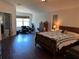 Spacious main bedroom featuring wood floors, a sitting area, and an ensuite bathroom for added privacy at 12822 Moss Park Ridge Dr, Orlando, FL 32832
