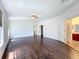 Spacious main bedroom featuring wood floors, a ceiling fan, and ensuite bathroom at 12822 Moss Park Ridge Dr, Orlando, FL 32832