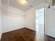 Walk-in closet features wood floors and shelving ready for storage and organization at 12822 Moss Park Ridge Dr, Orlando, FL 32832