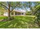 A large, well-maintained backyard with mature trees provides shade and privacy at 1320 Antrim Cir, Ormond Beach, FL 32174