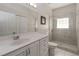 The bathroom has a bright vanity with drawers, a toilet, and a tile standing shower at 1320 Antrim Cir, Ormond Beach, FL 32174