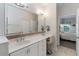 Bright bathroom with double sinks, large mirror, and vanity with drawers and cabinets at 1320 Antrim Cir, Ormond Beach, FL 32174