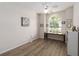 Bedroom space with hardwood floor, natural light, and ceiling fan with desk setup at 1320 Antrim Cir, Ormond Beach, FL 32174