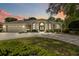 Lovely home with a well-manicured lawn, arched windows, and an attached two-car garage, perfect for Gathering living at 1320 Antrim Cir, Ormond Beach, FL 32174