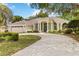 Charming single-story home boasting a curved driveway, a two-car garage, and verdant landscaping at 1320 Antrim Cir, Ormond Beach, FL 32174