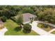 Well-maintained home boasting a lush lawn, mature landscaping, and a welcoming circular driveway at 1320 Antrim Cir, Ormond Beach, FL 32174