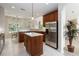 Bright kitchen featuring an island with quartz countertops, stainless steel refrigerator and adjacent dining area at 1320 Antrim Cir, Ormond Beach, FL 32174