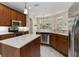 Well-equipped kitchen featuring an island, wooden cabinetry, stainless steel appliances, and recessed lighting at 1320 Antrim Cir, Ormond Beach, FL 32174