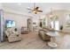 Bright open-concept living room with hardwood floors, comfortable seating, and a view of the adjacent dining area at 1320 Antrim Cir, Ormond Beach, FL 32174
