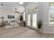 Bright and airy living room with wood floors, vaulted ceilings, a large window, and stylish, comfortable furniture at 1320 Antrim Cir, Ormond Beach, FL 32174