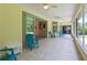 A comfortable screened porch with ceiling fans and furniture is perfect for outdoor living at 1320 Antrim Cir, Ormond Beach, FL 32174