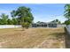 Spacious backyard with white fencing and a view of the home's rear exterior at 1328 Laurel Dr, Daytona Beach, FL 32117
