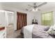 Cozy bedroom featuring hardwood floors, a ceiling fan, and a closet with paneled doors at 1328 Laurel Dr, Daytona Beach, FL 32117