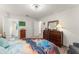 View of bedroom with wood-look floors, ceiling fan, and dresser with large mirror at 1328 Laurel Dr, Daytona Beach, FL 32117
