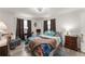 Bright bedroom with wood-look floors, ceiling fan, and natural light from two windows at 1328 Laurel Dr, Daytona Beach, FL 32117