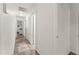 Hallway featuring hardwood floors, clean white walls, and multiple access doors at 1328 Laurel Dr, Daytona Beach, FL 32117