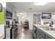 Well-lit kitchen featuring stainless steel appliances, stone countertops, and an open floor plan at 1328 Laurel Dr, Daytona Beach, FL 32117