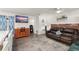 Combined living and kitchen area featuring wood floors, ample seating, and a large television at 1328 Laurel Dr, Daytona Beach, FL 32117