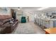 Open-concept living and kitchen area with wood floors, brick accents, and ample seating at 1328 Laurel Dr, Daytona Beach, FL 32117