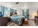 Spacious main bedroom featuring a large bed, bright blue curtains, and hardwood floors at 1328 Laurel Dr, Daytona Beach, FL 32117