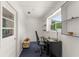 Compact home office with bright window, built in shelves, and comfortable workspace at 1328 Laurel Dr, Daytona Beach, FL 32117