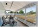 Covered patio with an outdoor dining area overlooking a large backyard with white fencing at 1328 Laurel Dr, Daytona Beach, FL 32117