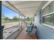 Inviting screened porch with tiled floor, table, chairs, and view of the neighborhood at 1328 Laurel Dr, Daytona Beach, FL 32117
