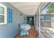 Cozy screened porch with tile flooring, table and chairs, and access to the front entrance at 1328 Laurel Dr, Daytona Beach, FL 32117