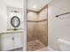 Stylish bathroom with a granite vanity, an oval mirror, and a tiled walk-in shower at 13489 Sw 60Th Avenue Rd, Ocala, FL 34473