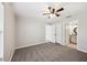 Nice bedroom featuring gray carpet, neutral paint, a ceiling fan, and an en-suite bathroom at 13489 Sw 60Th Avenue Rd, Ocala, FL 34473